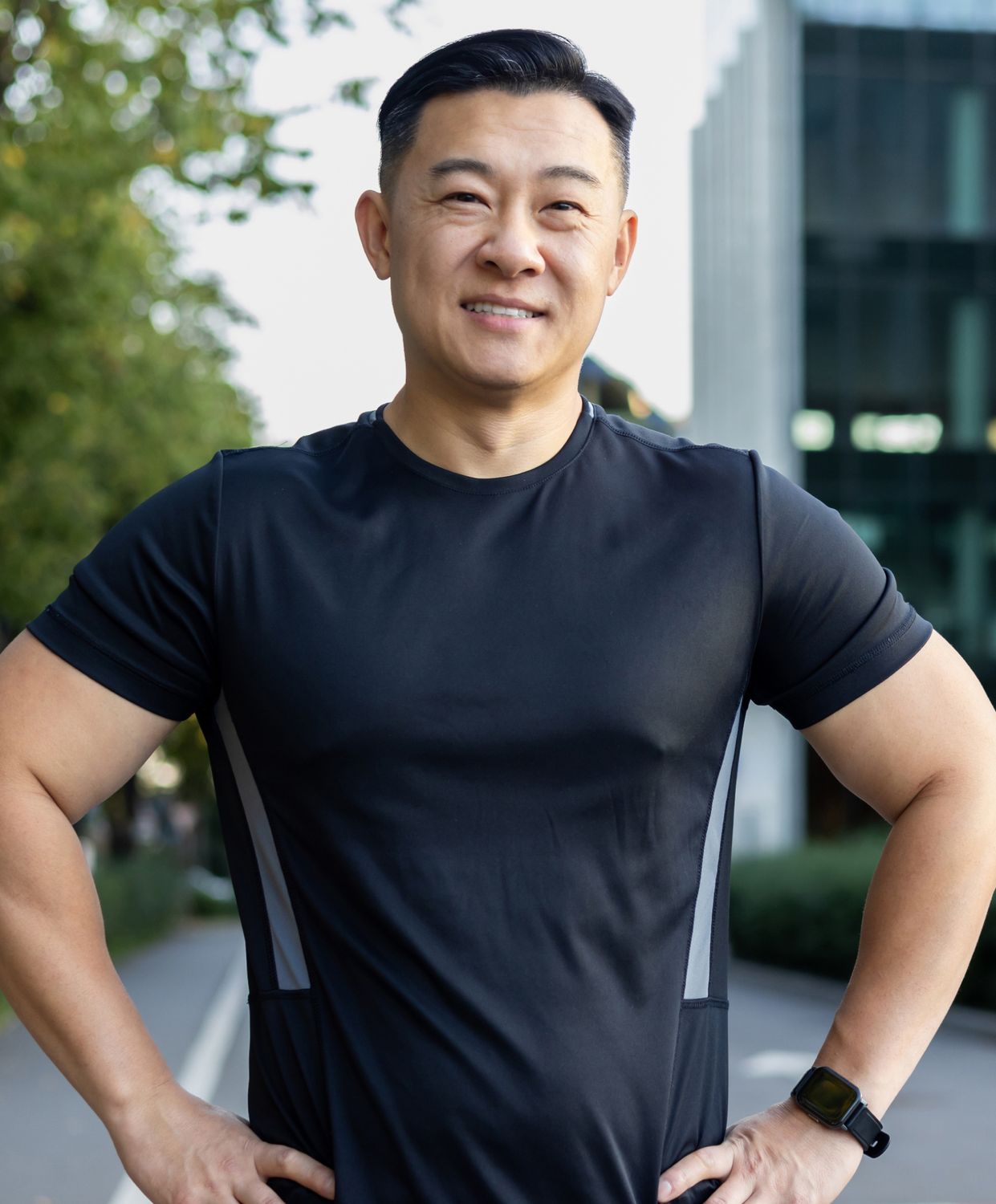 Smiling man in athletic wear outdoors.